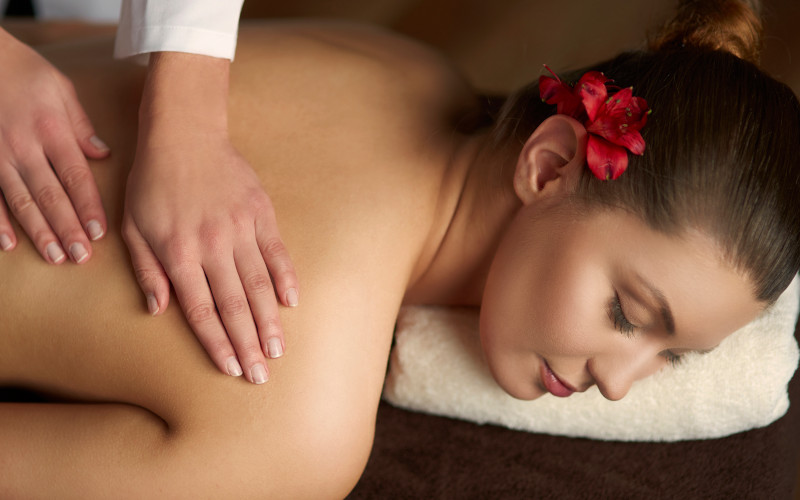 Lomi lomi Hawaiian massage using long flowing strokes for deep relaxation at Uniq Massage in McKinney, TX