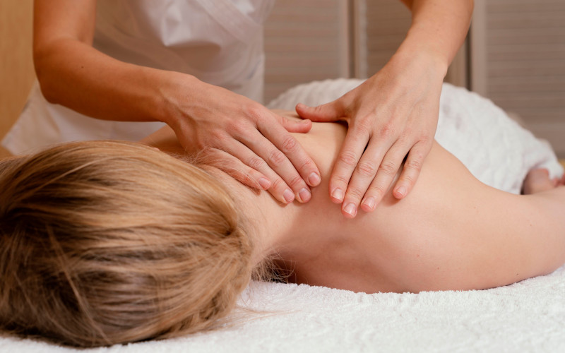 Swedish massage therapist performing a relaxing full-body treatment at Uniq Massage in McKinney, TX